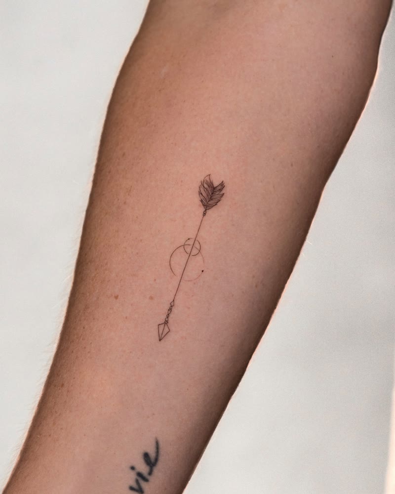 Delicate fine line arrow tattoo